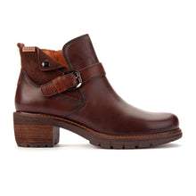 A dark brown leather ankle boot with a chunky block heel, a decorative strap across the instep with a metal buckle, and a pull tab on the side