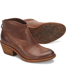 Brown leather ankle boots with floral embossing on the sole