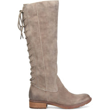 A tall knee-high suede boot in a taupe gray color, featuring a side lace-up closure and a low stacked heel
