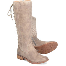 A pair of knee-high taupe suede boots with side lacing and a low block heel