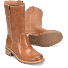 A pair of tan leather mid-calf boots, featuring a stacked wooden heel and a tan pull tab.