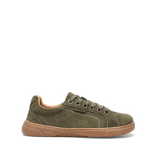 A woman's olive green suede low-top sneaker with a tan rubber sole