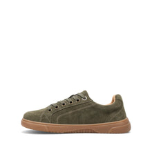 A woman's olive green suede low-top sneaker with a tan rubber sole