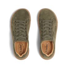 A woman's olive green suede low-top sneaker with a tan rubber sole