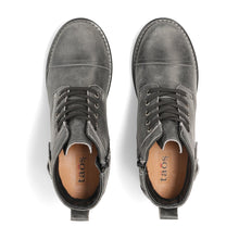 A dark gray distressed leather lace-up ankle boot with a stacked block heel, a buckle strap detail on the side, and a black sole