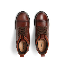 Women's brown leather boot with a buckle detail on heel, having a zipper and lace up closure.