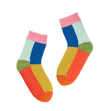 Colorful socks with pink cuffs and green accents 
